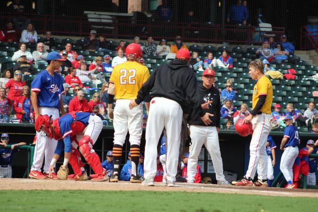 Dale's baseball coaches and players react to the umpire's call of malicious contact by Dayton Forsythe, far right, after Forsythe slid into the Silo catcher at home plate during the Class A State Fall Baseball Championship on Oct. 8. Countywide &amp; Sun/Natasha Dunagan
