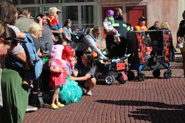 Contestants and parents in the 0-3-year costume contest wait for the judges' decision during Monsters on Main in downtown Shawnee, Oct. 22. The "Claw Machine," far right, with Alivia Powell, 1, daughter of Falon and Bralynn Powell, of Tecumseh, won second place. Countywide &amp; Sun/Natasha Dunagan
