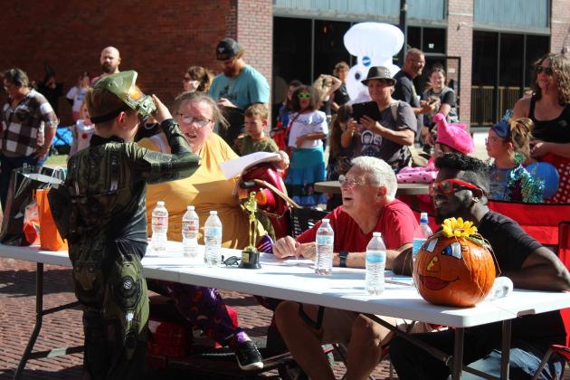 Costume contest judges Teresa Likens, Shawnee Mayor Ed Bolt, and Jamelle Payne listen as a contestant tells them which Halo character he is playing during the 8-12-year division at Monsters on Main in downtown Shawnee, Oct. 22. Countywide &amp; Sun/Natasha Dunagan