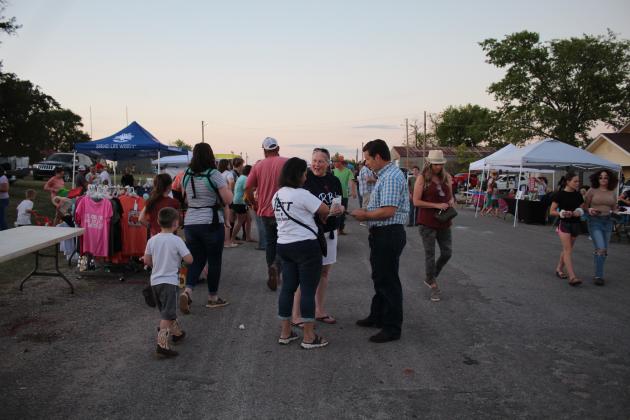Oklahoma Senator Shane Jett and his wife, Ana, speak with Linda Weiss, of Macomb, during Macomb Trade Days on Sept. 23. Weiss's sons, Jonathan and Andrew, both paged for Jett in the past. Ana said she and Shane were there to support local businesses.
