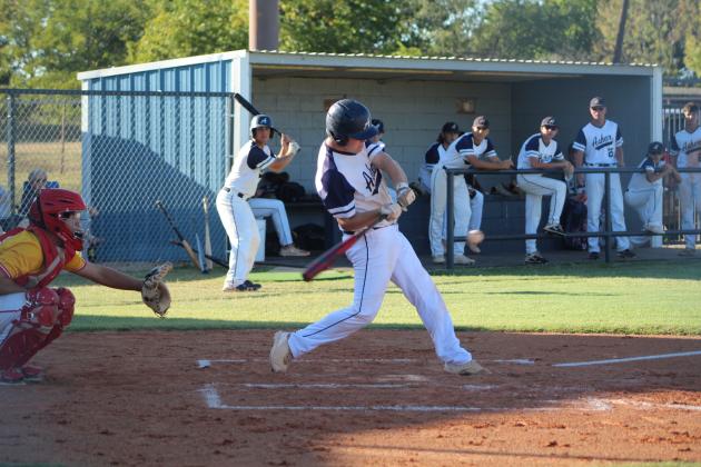 Asher's Brian Ballard hits a single, as Dale catcher Ethan Douglas is ready to catch the ball, during the Asher home game on Sept. 26. Dale won that game, 12-0. Since then, Asher lost their regional games at Roff, 3-16, and with Buffalo Valley, 13-14. Countywide &amp; Sun/Natasha Dunagan