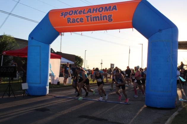 Runners take off from the starting line during the Frenzy on Federal at the Shawnee BancFirst Harrison branch on Oct. 1. There were 60 participants in the 5K Race this year. Countywide &amp; Sun/Natasha Dunagan