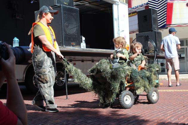 Misha Fowler, of Meeker, pulls her "Duck Commander Air Boat" with Deacon Fowler, 1, and Amelia Hennigh, 2, during the 0-3 year costume contest at Monsters on Main in downtown Shawnee, Oct. 22. Fowler won first place. Countywide &amp; Sun/Natasha Dunagan