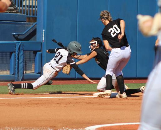 Tecumseh pitcher Serenity Jacoway tags a Lone Grove runner as she tries to dive back to third base and as third baseman Katelyn Fleming looks on, during the first inning of the Class 4A State Fastpitch Championship on Oct. 15. This was the third out. Countywide &amp; Sun/Natasha Dunagan