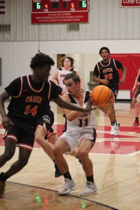 Macomb's Cameron Richardson guards the ball as he heads to the basket during the first quarter of the home game against Paden on Nov. 4. Macomb lost, 17-61. Countywide &amp; Sun/Natasha Dunagan