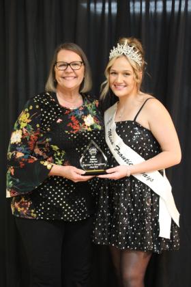 The Farmer's Daughter Market owner Deann Smith accepts the Business of the Year Award from Miss Frontier Days Sadie Boatman during the Tecumseh Chamber of Commerce Annual Meeting and Business Awards Banquet on Nov. 14 in the City Hall Auditorium. Countywide &amp; Sun/Natasha Dunagan