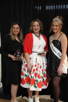 Becky Webb, with A/C Doctors, LLC, and Julie Mattias, of Rustic Rose, accept the Small Business of the Year Award from Miss Frontier Days Sadie Boatman during the Tecumseh Chamber of Commerce Annual Meeting and Business Awards Banquet on Nov. 14. The two businesses won in a tie. Webb also won Friendliest Employee, and Rustic Rose owner Luke Fugate (not present) won Businessperson of the Year. Countywide &amp; Sun/Natasha Dunagan