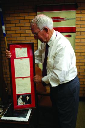William Ford, of Shawnee, holds up a framed set of letters from and a picture of himself shaking hands with four-star General Tommy Franks, whom he trained in U.S. Army Artillery and Missile Officer Candidate School at Fort Sill in 1967. Countywide &amp;amp; Sun/Natasha Dunagan