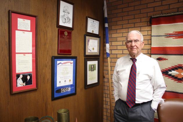 Army Captain William "Bill" Ford, of Shawnee, stands by a wall in his office at Shawnee Milling Company, which is decorated with several military and Boy Scout accolades, including an artist's rendition of his portrait and his induction certificate, both for the Oklahoma Military Hall of Fame, and a framed collection of letters from General Tommy Franks. Countywide &amp; Sun/Natasha Dunagan