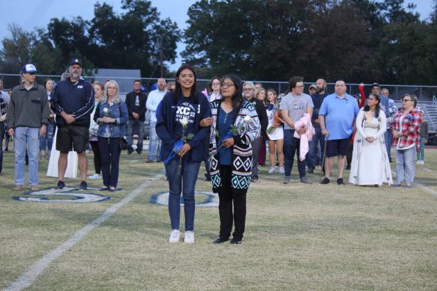 Shawnee cross-country senior Mariah LaPierre and her grandmother are recognized during Senior Night ceremonies on Thursday, Nov. 3, before the home football game. Also shown, far left, is fellow cross-country senior Alex Porter and his family. There were 46 seniors honored in cross country, football, band, color guard, choir, cheer, and pom. Countywide &amp; Sun/Natasha Dunagan