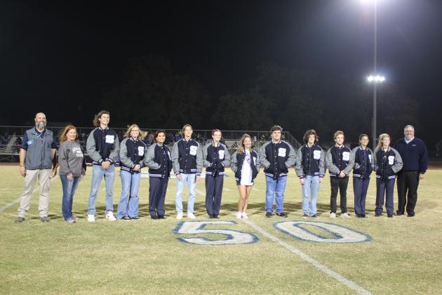 Sponsored by Arvest Bank, academic letter jackets were presented to 11 Shawnee seniors during half-time of the home football game on Nov. 3. Shown, from left, are Shawnee High School Principal Matt Johnson, Arvest representative Jill Rawls, Titus Wright, Eva Webb, DezaRae Simmons, Cruz Merrell, Scottland Meier, Mia Jennings, Cole Hodges, Matthew Ellis, Luke Dyer, Chiara Carpenter, Keilani Anderson and Arvest Community Bank President Brian Nave. Countywide &amp; Sun/Natasha Dunagan