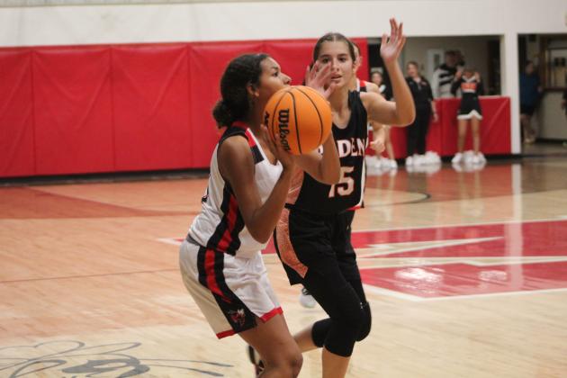 Macomb freshman McKenzie Brummett prepares to sink a three-point shot in the fourth quarter of the game against Paden on Nov. 4. Macomb lost, 30-49. Countywide &amp; Sun/Natasha Dunagan