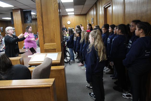 The Jefferson Honor Choir, led by Teresa Swadley, perform for the Shawnee Board of Education at their meeting on Nov. 7. Countywide &amp; Sun/Natasha Dunagan