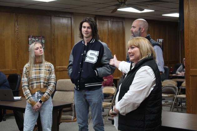 Michelle Wallace, Shawnee Public Schools Career Development and Community Partnership Advisor, introduces Shawnee senior Titus Wright to the Shawnee Board of Education on Nov. 7. Also shown are fellow senior Natalie Selman and SHS Principal Matt Johnson. The seniors spoke about their experiences at the senior conference and with internships. Countywide &amp; Sun/Natasha Dunagan