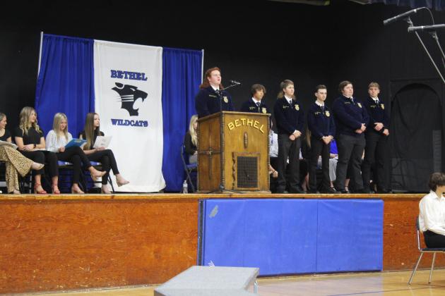 Colton Ingersoll recites part of "Ragged Old Flag" by Johnny Cash, as other members of the Bethel FFA Officers Team wait their turn at Bethel High School's Veterans Day Program on Nov. 11 in the Old Gym. Countywide &amp; Sun/Natasha Dunagan
