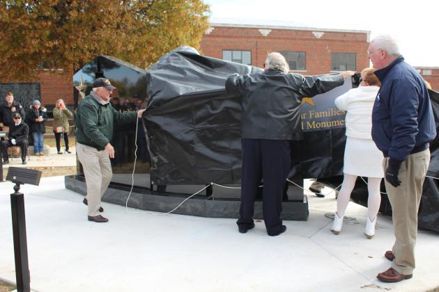 The Gold Star Families Memorial Monument is unveiled at Woodland Veterans Park in Shawnee during the Oklahoma Veteran's Memorial Committee Veterans Day Program on Nov. 11. Shown, from left, are Bill Ford, Marvin Warren, Jr., Donna Warren and Patrick O'Leary, a representative from the Woody Williams Foundation, which constructed the monument. Nancy Ford also assisted in the unveiling. Countywide &amp; Sun/Natasha Dunagan
