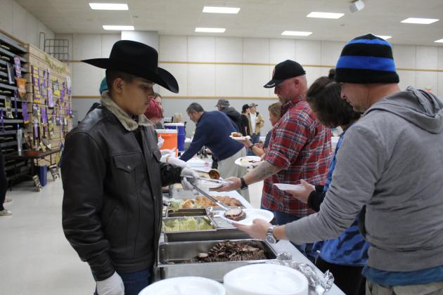 Tecumseh FFA eighth-grader Christian Falcon serves pork during the Annual Pig Roast at Tecumseh High School's Alumni Center on Nov. 18. According to a post on the Tecumseh FFA Facebook page, they had a "tremendous crowd and raised a record amount." Countywide &amp; Sun/Natasha Dunagan