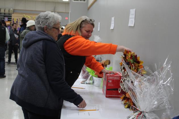 Sarah Flowers, the mother of Tecumseh FFA president Maci Flowers, and MaryAnn Kelsey, Maci's grandmother, look over a wreath in the silent auction of the Tecumseh FFA Pig Roast on Nov. 18. Countywide &amp; Sun/Natasha Dunagan