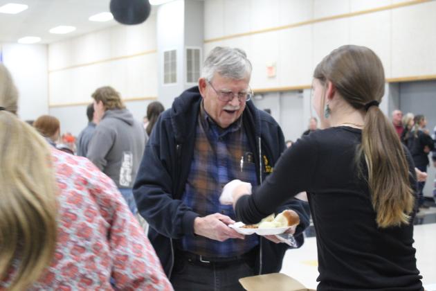 Tecumseh FFA eighth-grader Abbi Jordan serves beans to Tecumseh Mayor Eddy Parker during the Annual Pig Roast on Nov. 18. According to a post on the Tecumseh FFA Facebook page, they had a "tremendous crowd and raised a record amount." Countywide &amp; Sun/Natasha Dunagan