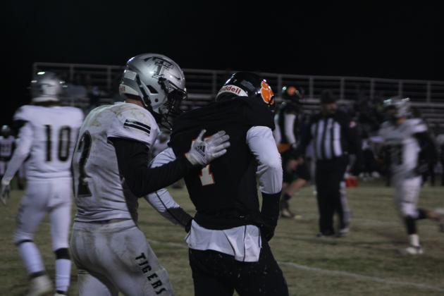 Timberlake's Merric Judd pats Maud's Braxton Street on the back after tackling him in the fourth quarter of the Class C OSSAA Quarterfinal game at Maud on Nov. 18. After winning 11 games straight, the Maud Tigers lost to the Timberlake Tigers, 24-64. Countywide &amp; Sun/Natasha Dunagan