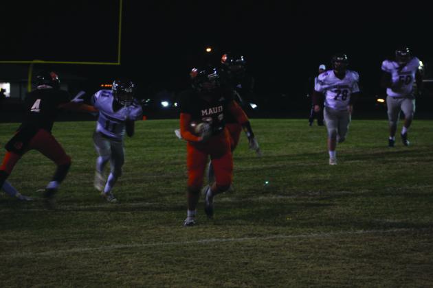 Maud freshman Beau Willis carries the ball during the Class C first-round playoff home game against Oaks Mission on Nov. 11. Maud won their 11th straight game, and it was called at half time, 60-8. Countywide &amp; Sun/Natasha Dunagan