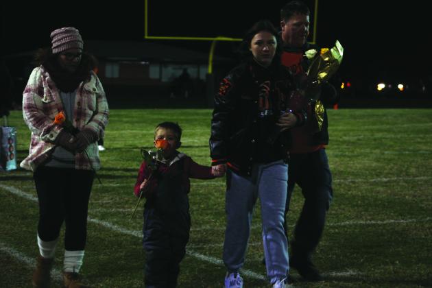 Maud senior and football manager, Madison Dustman, holds hands with her little brother, Keaton, as her parents, Kurtis and Marcie Dustman, walk with her onto the football field during Senior Night ceremonies on Nov. 11. Senior football players, cheerleaders and football managers were honored that night. Countywide &amp; Sun/Natasha Dunagan