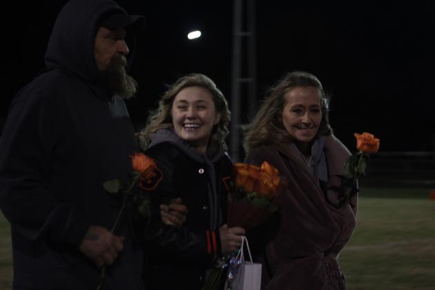 Maud senior and football manager Isabella Ramirez smiles as she walks onto the football field with her parents Bronk Berry and Sherri Ramirez during Senior Night on Nov. 11. Ceremonies were held following the Class C first-round playoff home game against Oaks Mission, which Maud won, 60-8 by halftime. Countywide &amp; Sun/Natasha Dunagan