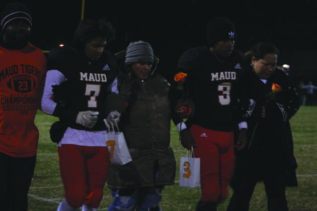 Maud seniors Braxton Street (#7) and Vcake Wassana (#3) and their parents, Royce and Brooke Street, and another family member walk out to the football field during Senior Night ceremonies following the Class C first-round play-off game against Oaks Mission on Nov. 11. Maud won their 11th straight game, and it was called at half time, 60-8. Countywide &amp; Sun/Natasha Dunagan