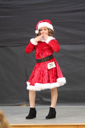 Peyton Neely, 7, of Shawnee blows kisses as she competes in the 28th Annual Christmas Miss &amp; Mister Pageant on Dec. 3 at Will Rogers Elementary in Shawnee. Neely won the Overall Christmas Queen for her age division. Countywide &amp; Sun/Natasha Dunagan