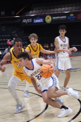 Bethel's Bray Bussell takes the ball to the hoop in the third quarter of Bethel's First United Basketball Classic on Dec. 8 at FireLake Arena. The Wildcats won against Tecumseh, 69-55, but lost to Prague, 48-63, and to Perkins-Tryon, 50-55, over the next two days. Also shown, from left, are Tecumseh's Marquan Krush and Kohen Warden, and Bethel's D.J. Whitten. Countywide &amp; Sun/Natasha Dunagan