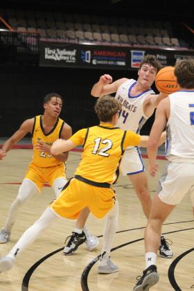 Bethel's Bronc Robbins hands the ball off to Xavier Meier in the second quarter of the Bethel's First United Basketball Classic on Dec. 8 at FireLake Arena. Also shown are Tecumseh's Marquan Krush and Kohen Warden. The Wildcats won against Tecumseh, 69-55, but lost to Prague, 48-63, and to Perkins-Tryon, 50-55, over the next two days. Countywide &amp; Sun/Natasha Dunagan