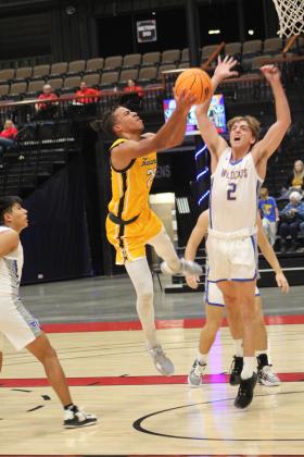 Tecumseh junior Marquan Krush goes to the hoop, as Bethel's Xavier Meier guards it, during Bethel's First United Basketball Classic on Dec. 8 at FireLake Arena. During the three-day tournament, the Savages lost to the Wildcats, 56-69, and to Clinton, 40-43, before winning, 82-12, over Astec Charter. Countywide &amp; Sun/Natasha Dunagan