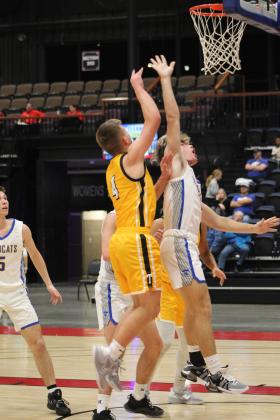 Tecumseh senior Brady Overstreet shoots over Bethel's R.J. Morris during Bethel's First United Basketball Classic on Dec. 8 at FireLake Arena. During the three-day tournament, the Savages lost to the Wildcats, 56-69, and to Clinton, 40-43, before winning, 82-12, over Astec Charter. Countywide &amp; Sun/Natasha Dunagan