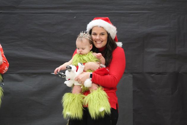 Hattie Jo Yount won Most Beautiful, Photogenic and Christmas Fashion Queen in the 0-12 month girls division at the Christmas Miss &amp; Mister Pageant at Will Rogers Elementary on Dec. 3. Yount is held by her mother, Micaela Yount, who is a teacher in Shawnee. Countywide &amp; Sun/Natasha Dunagan