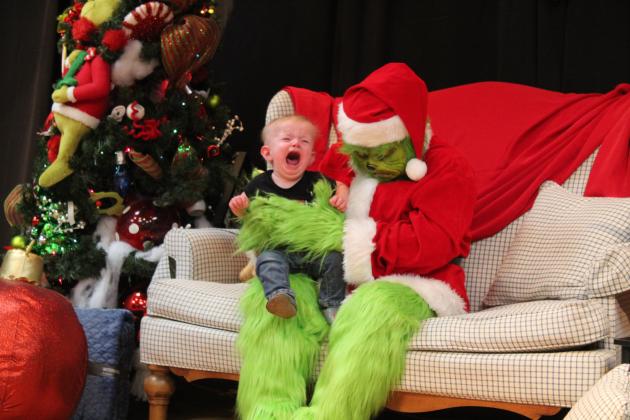 One baby did not want his picture taken with the Grinch on Dec. 8, following the Grinchmas Holiday Parade and Marching Band Contest. Free photos with the Grinch, free cocoa, crafts, games and face painting were available in "Whoville" at the Tecumseh City Hall Auditorium. Around 200 photos were taken and printed by Tecumseh Public Library employees and can still be claimed at the library. Countywide &amp; Sun/Natasha Dunagan