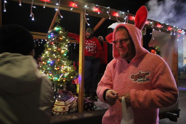 Pottawatomie County Emergency Management Volunteer Stephen Therrien walks alongside their float during the Shawnee Christmas Parade on Dec. 1. Countywide &amp; Sun/Natasha Dunagan