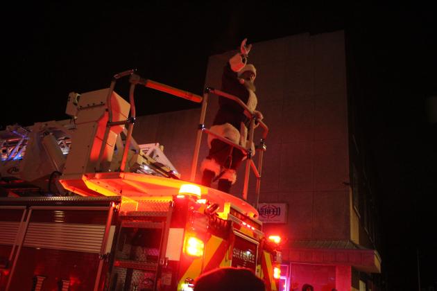 Santa Claus waves from the back of a Shawnee Fire Engine during the Shawnee Christmas Parade, organized by Community Renewal. There were 88 entries in the parade this year, and it was followed by fireworks. Countywide &amp; Sun/Natasha Dunagan