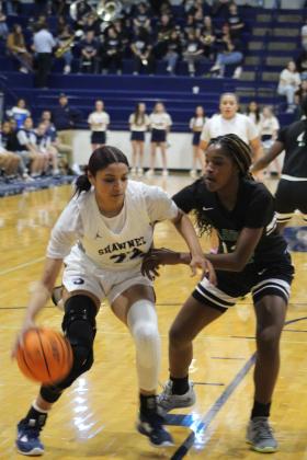 Shawnee senior Amaya Martinez heads into the paint during the first quarter of the homecoming game against Harding Charter on Jan. 10. The Lady Wolves lost, 34-39, and the Wolves won in overtime, 69-63. Countywide &amp; Sun/Natasha Dunagan