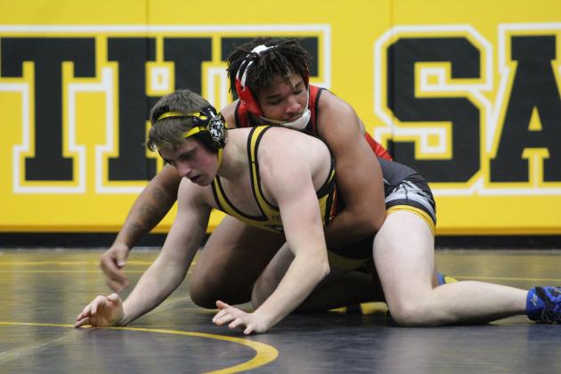 In the 215-pound class, Tecumseh's Jacob Frazier concentrates on breaking free from McLoud's Zak Osborn during the homecoming dual meet on Jan. 10 at the Tecumseh Middle School Gym. The McLoud Redskins won 38-33, and the Lady Redskins won 48-24  Countywide &amp; Sun/Natasha Dunagan