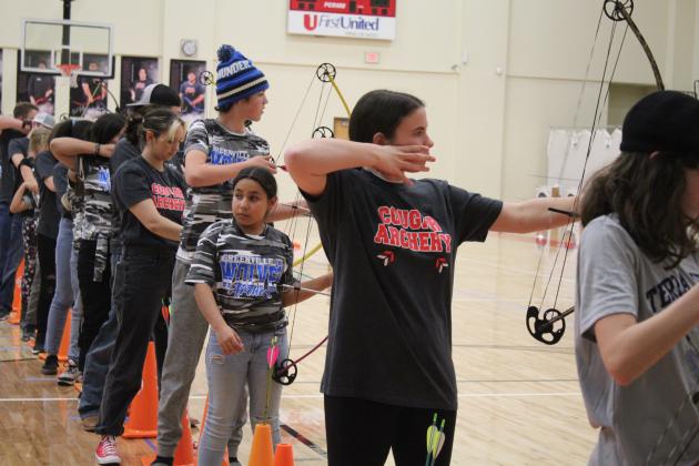 North Rock Creek students (in "Cougar Archery" shirts) Kenzi Tosh and Addison Iddings compete in the NASP Tournament, held at NRC Middle School Jan. 13-14. About 600 archers in fifth through 12th grade from 25 Oklahoma schools participated. Countywide &amp; Sun/Natasha Dunagan