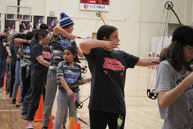 North Rock Creek students (in "Cougar Archery" shirts) Kenzi Tosh and Addison Iddings compete in the NASP Tournament, held at NRC Middle School Jan. 13-14. About 600 archers in fifth through 12th grade from 25 Oklahoma schools participated. Countywide &amp; Sun/Natasha Dunagan
