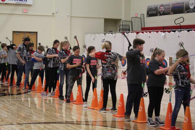 The second flight of up to 48 archers aim and shoot compound bows. About 600 students from 25 Oklahoma schools participated in the NASP Tournament, held at North Rock Creek Middle School Gym, Jan. 13-14. Countywide &amp; Sun/Natasha Dunagan