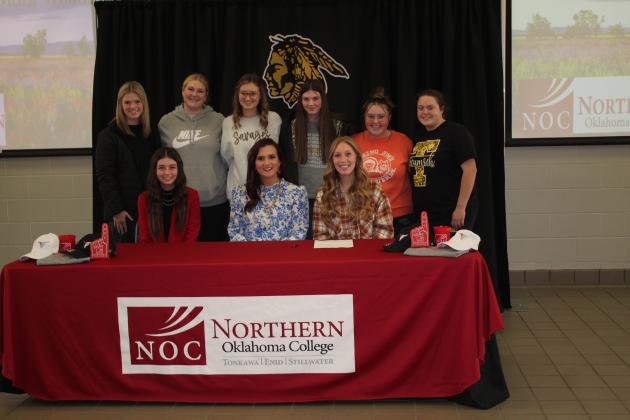 Jocelyn Phelps and Marli Williams sign with NOC for livestock judging. Also shown are members of the Tecumseh FFA Chapter Officers, standing, and NOC Livestock Judging Coach and Professor Jennifer Bedwell, seated center.