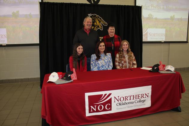 Jocelyn Phelps and Marli Williams sign with NOC for livestock judging. Also shown, standing are Randy and Suzanne Gilbert, and NOC Livestock Judging Coach and Professor Jennifer Bedwell, seated center.