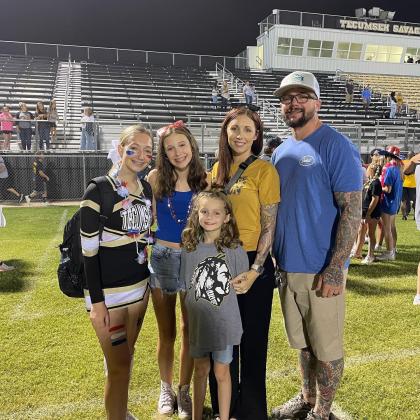Jacob Warner, also known to his YouTube fans as ‘Puddin’, enjoys a Tecumseh football game on Sept. 9, 2022 with his three daughters Hailee, Kayley, and Ella and his wife, Ashley. Countywide &amp; Sun/Adriana Fincher