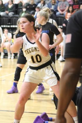 Tecumseh sophomore Katie Overstreet passes the ball from under the basket during the third quarter of the home game with Harrah on Feb. 10. The Lady Savages won, 55-44, and the Savages also won that night, 71-51. Countywide &amp; Sun/Natasha Dunagan