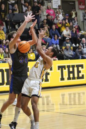 Tecumseh's Marquan Krush is blocked by Bethel's Bronc Robbins as he goes in for the basket and gets the foul in the fourth quarter of the Tecumseh homecoming game, Feb. 3. Countywide &amp; Sun/Natasha Dunagan