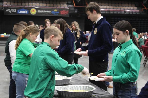 Tecumseh 4-H Club member Preston Haines, left, serves pickles during the 34th Annual Pottawatomie County Junior Livestock Show Pig Roast and Trophy Auction on Feb. 6. Countywide &amp; Sun/Natasha Dunagan
