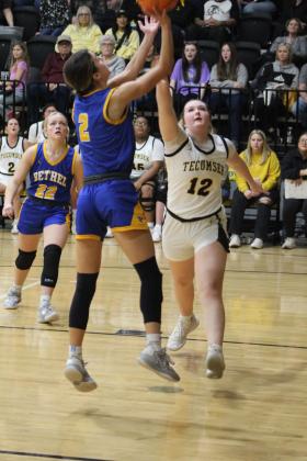 Bethel's Baylee Tapley makes her shot, as Tecumseh's Samantha Schweighardt guards, in the second quarter of the game at Tecumseh on Feb. 3. The Lady Savages lost, 42-56. Countywide &amp; Sun/Natasha Dunagan
