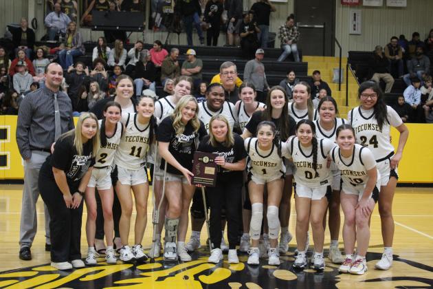 The Tecumseh Lady Savages and their coaches Eldon Gentry, Montana Palmer and Bill Grogan pose with their Class 4A District Champion trophy after beating Crossings Christian on Feb. 17. The Lady Savages won that night, 79-26. Their record is at 19-5. Countywide &amp; Sun/Natasha Dunagan